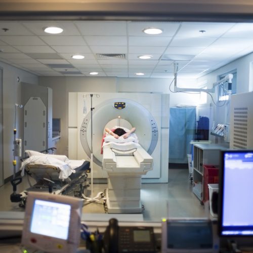View looking through a radiation shielded glass window at an MRI machine